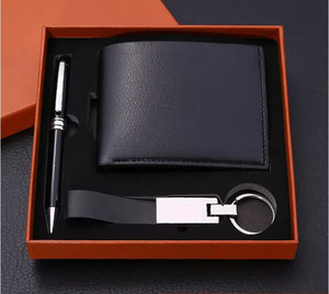 Accessory box containing a key ring, wallet, and pen set.